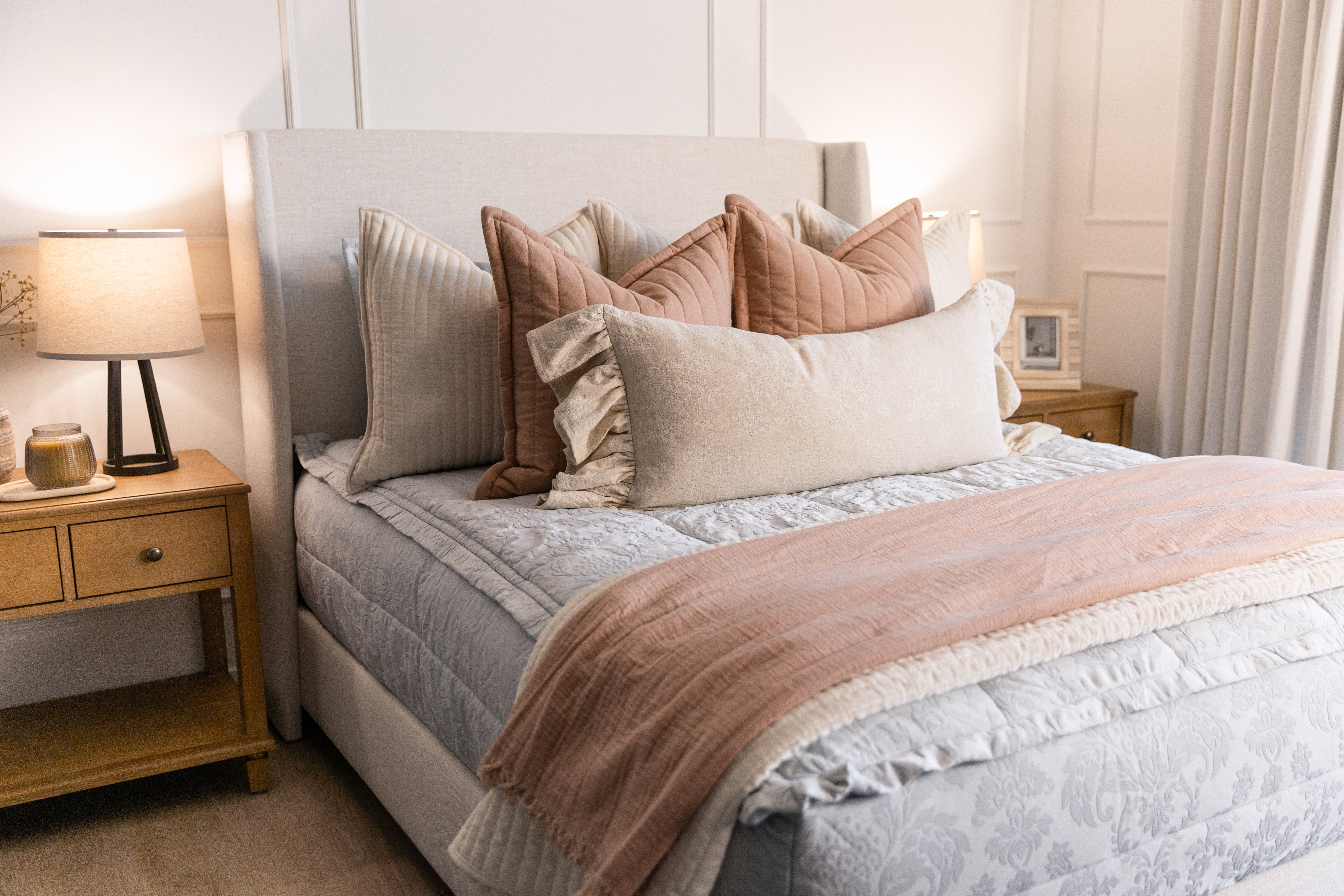 Light blue floral embossed zipper bedding with cream tan and terracotta accessories