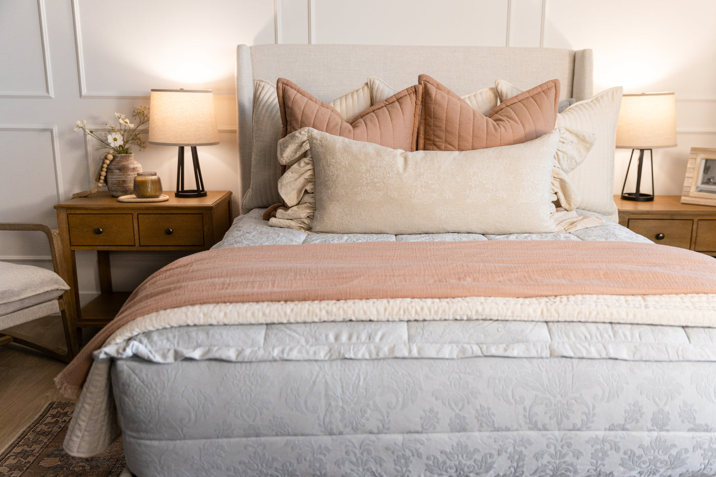 A light blue floral embossed zipper bedding with cream tan and terracotta accessories