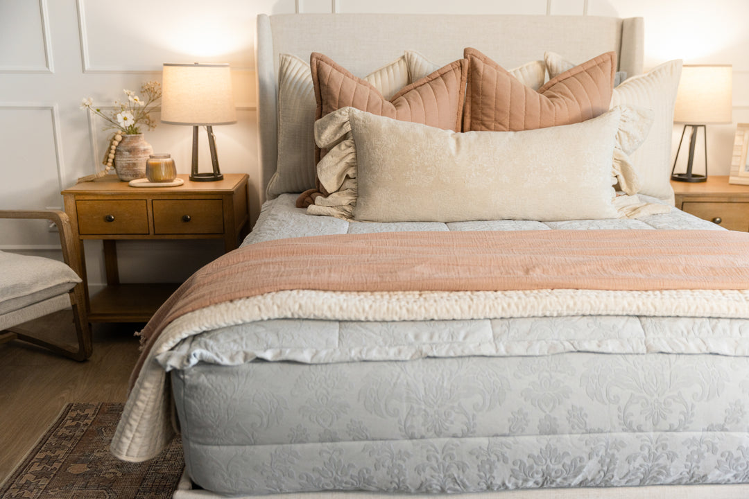 Light blue floral embossed zipper bedding with cream tan and terracotta accessories