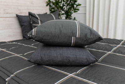 Black plaid sham stacked on top of a black heathered pillowcase