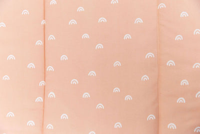 close up of peachy pink rainbow printed bedding