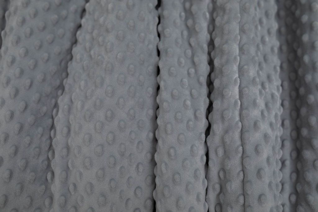 A close up of a deep gray softly textured minky blanket.