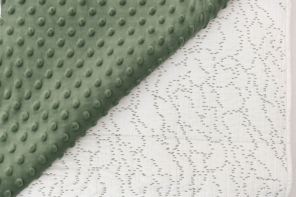 double sided blanket, one side in green minky and. the other with white and green stitching