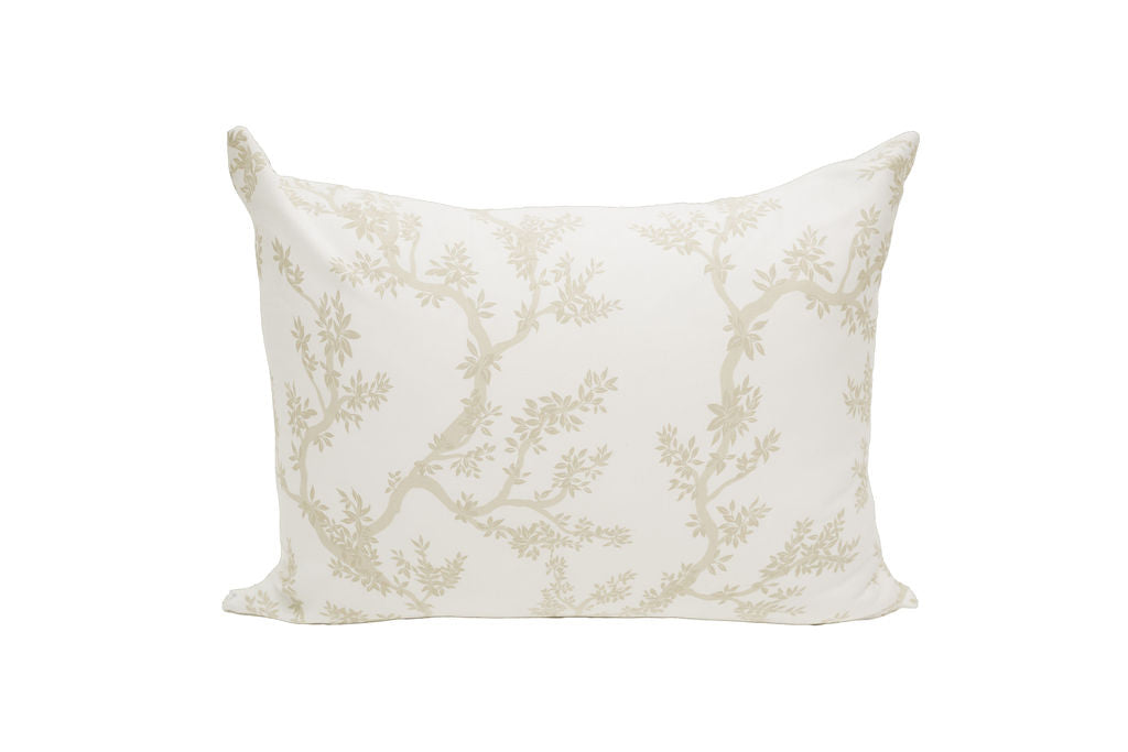 A white pillowcase with a tan design of treebranches