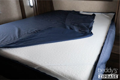 A ZipBase sheet partially unzipped and pulled back to show how it detaches from the rest of the base sheet wrapped around the sides of the mattress.