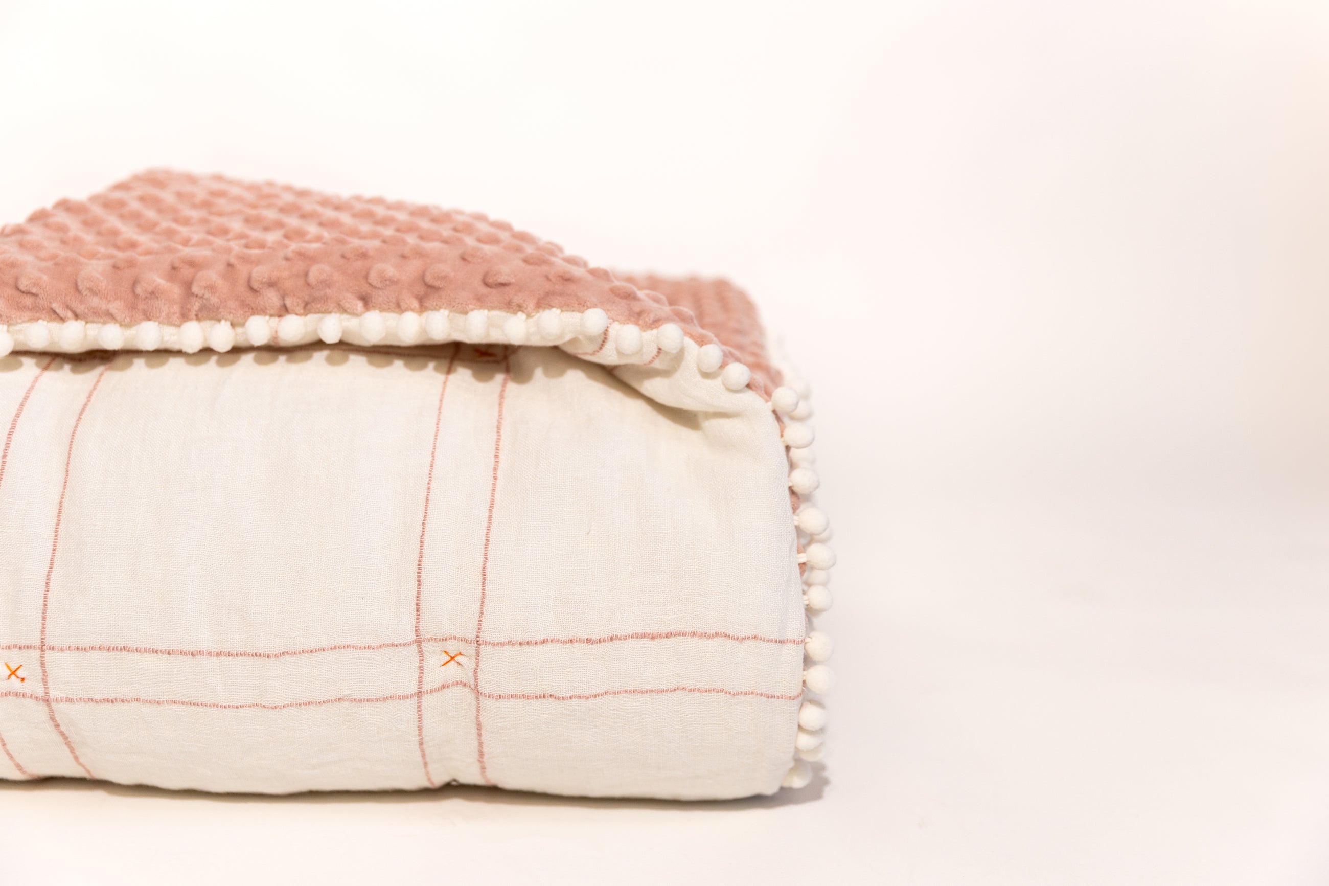 White background photo of white and pink blanket
