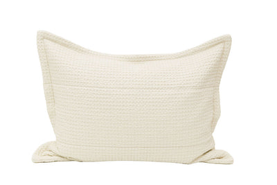 A cream waffle textured pillow sham on a white background.