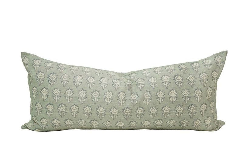An XL lumbar pillow in a green-blue shade with a floral pattern