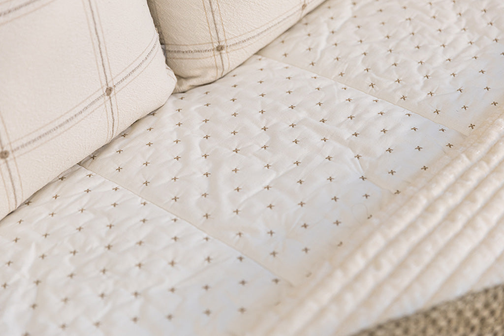 Close up photo of cream embroidered  zipper bedding.