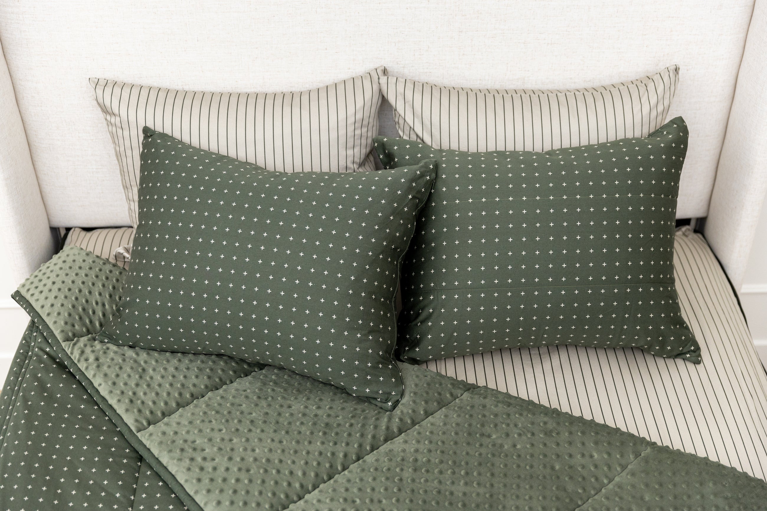 Overhead shot of green zipper bedding showing pillowcases and shams