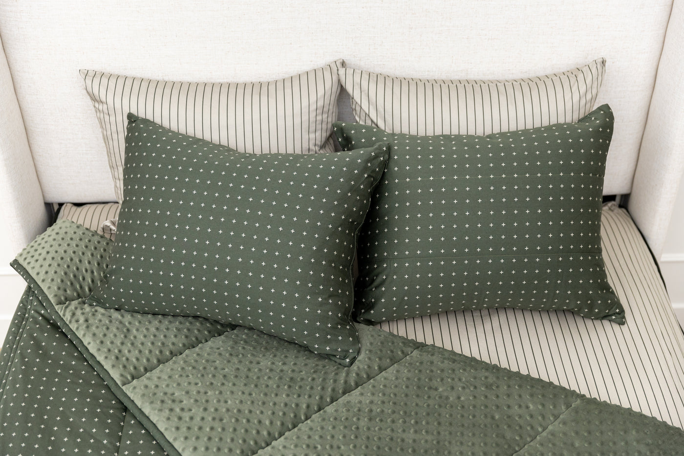 Overhead shot of green zipper bedding showing pillowcases and shams