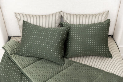 Overhead shot of green zipper bedding showing pillowcases and shams