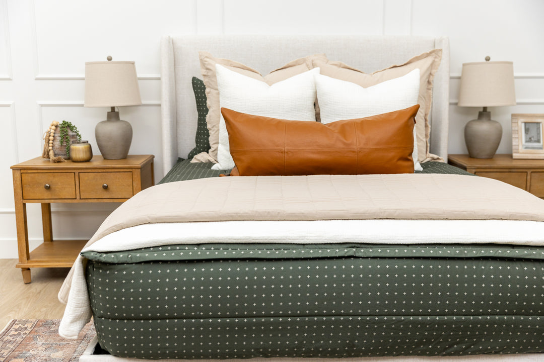Green zipper bedding with white cream and tan accessories