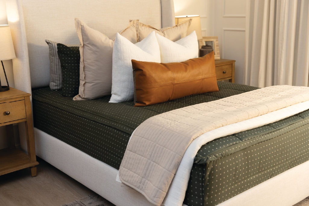 Green zipper bedding with white cream and tan accessories