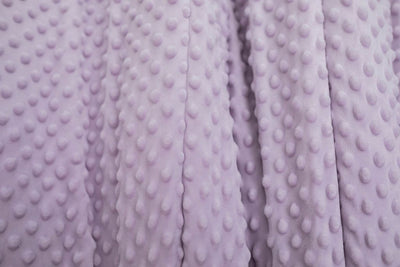 A close up of a light purple softly textured minky blanket. 