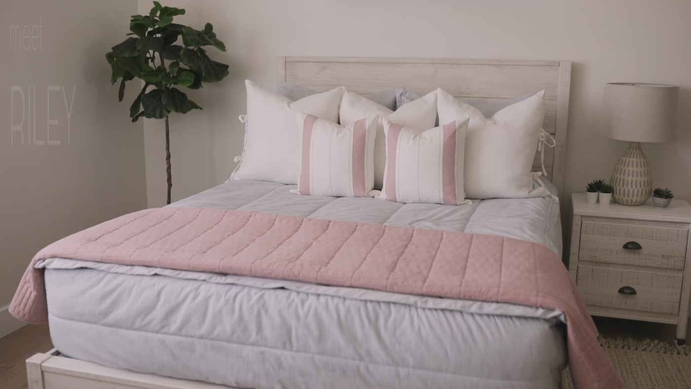 Video highlighting Light blue zipper bedding styled with matching white, blue and pink pillows and pink blanket