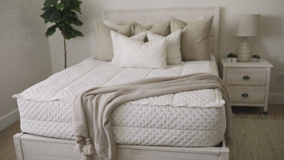 Video highlighting White and cream zipper bedding with brown stitching styled with matching pillows and blanket