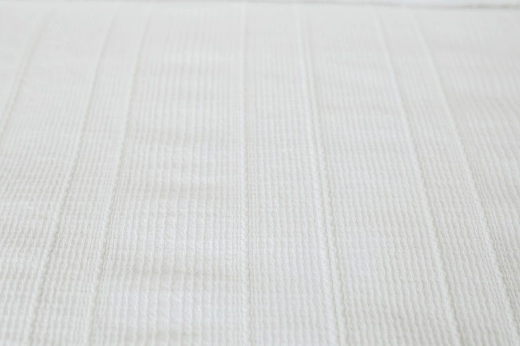 Close up view of texture on white duvet bedding