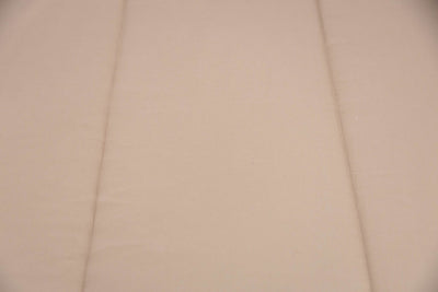 A close up view of a tan zipper bedding exterior.