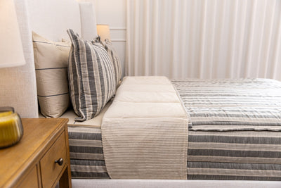 Side view of classic neutral stripe zipper bedding.