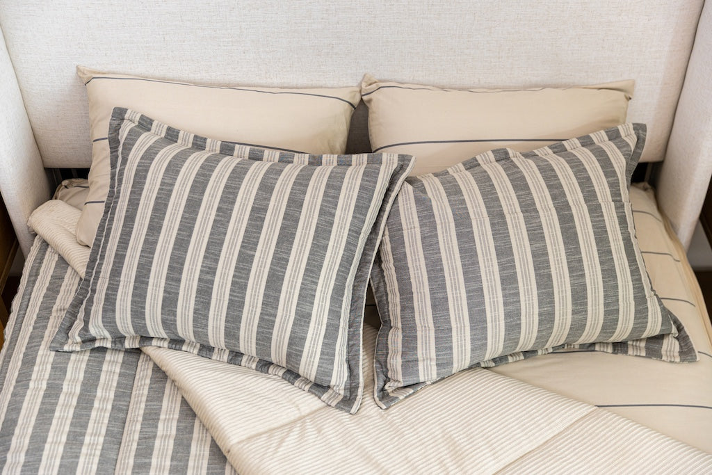 Overhead photo of classic stripe zipper bedding with distressed gray striped bed sheets and tan corduroy minky interior.