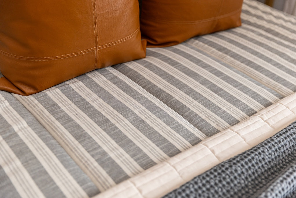 Close up photo of classic neutral stripe zipper bedding 