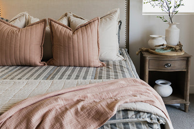 Classic neutral stripe zipper bedding with cream and terracotta accessories.