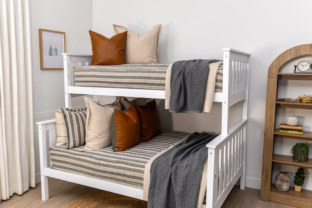 A bunk bed made with classic neutral stripe zipper bedding with tan, gray and rustic accessories.