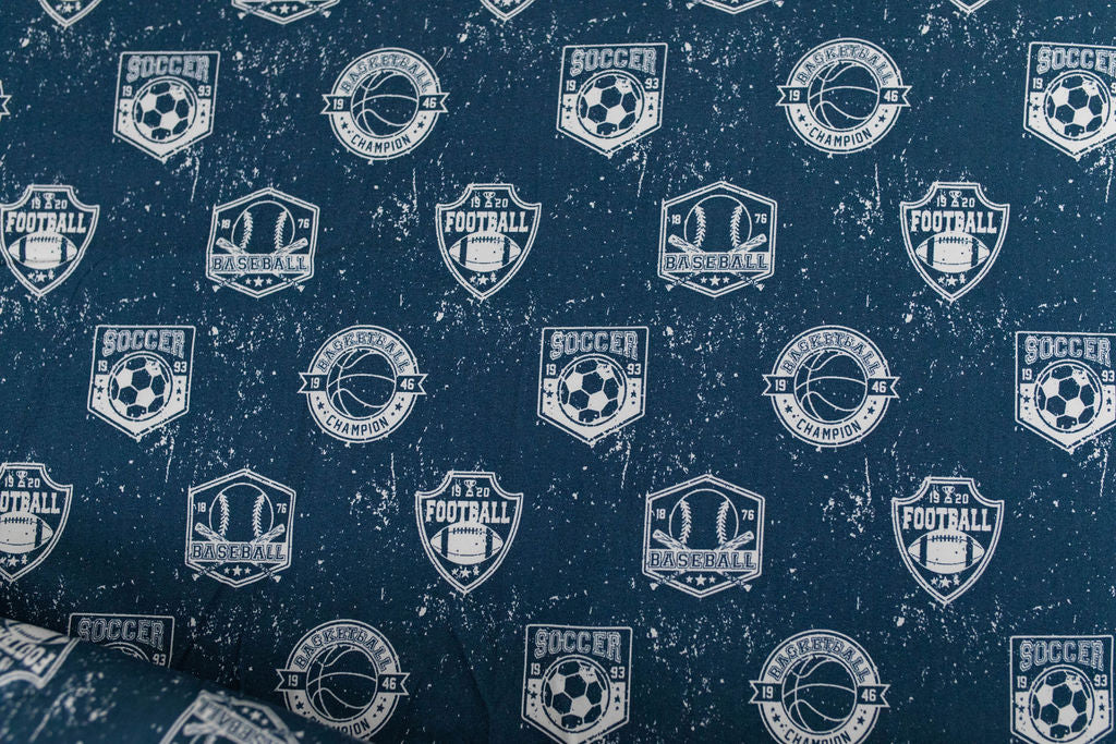 A closeup on the interior of a set of blue sports themed kids zipper bedding