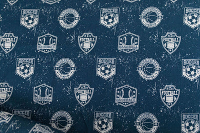 A closeup on the interior of a set of blue sports themed kids zipper bedding