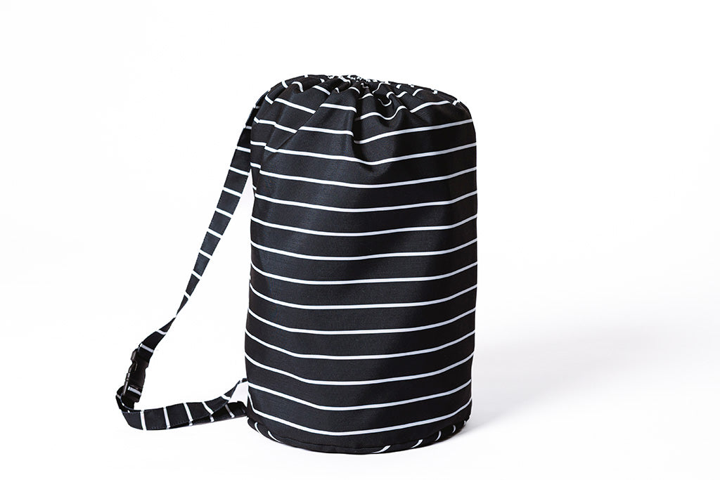 A black and white striped stadium bag standing upright. 