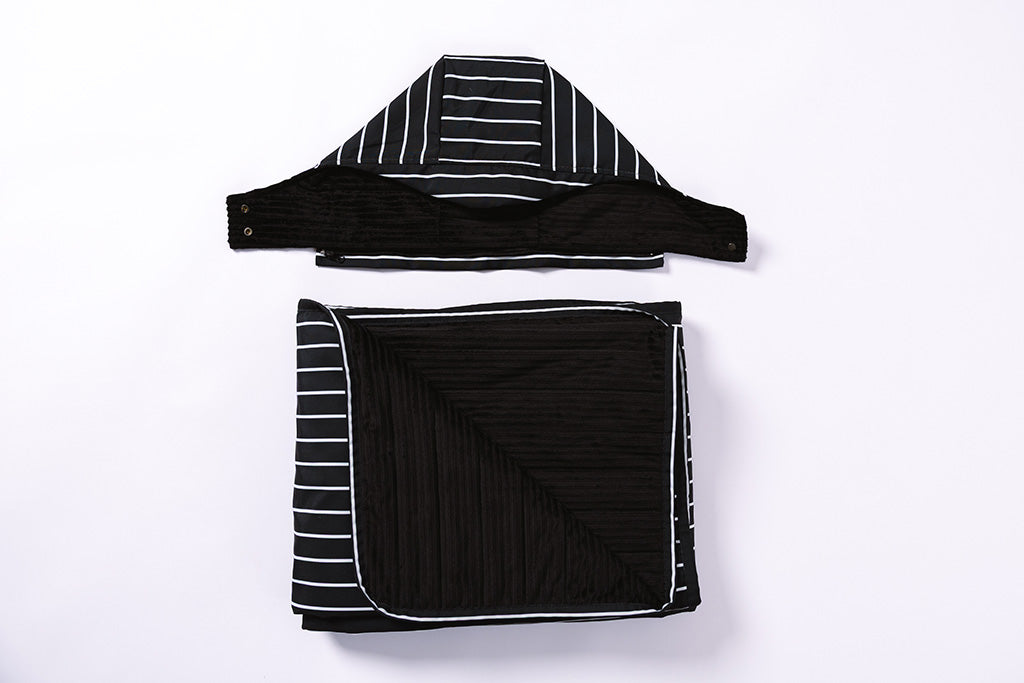 The hood of the stadium blanket detached  laying flat on a white background.