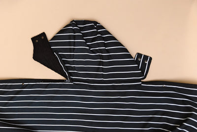 Partially unzipped detachable hood of the stadium blanket on a tan background.