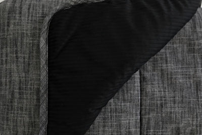 A charcoal gray blanket folded to reveal the interior black minky fabric.