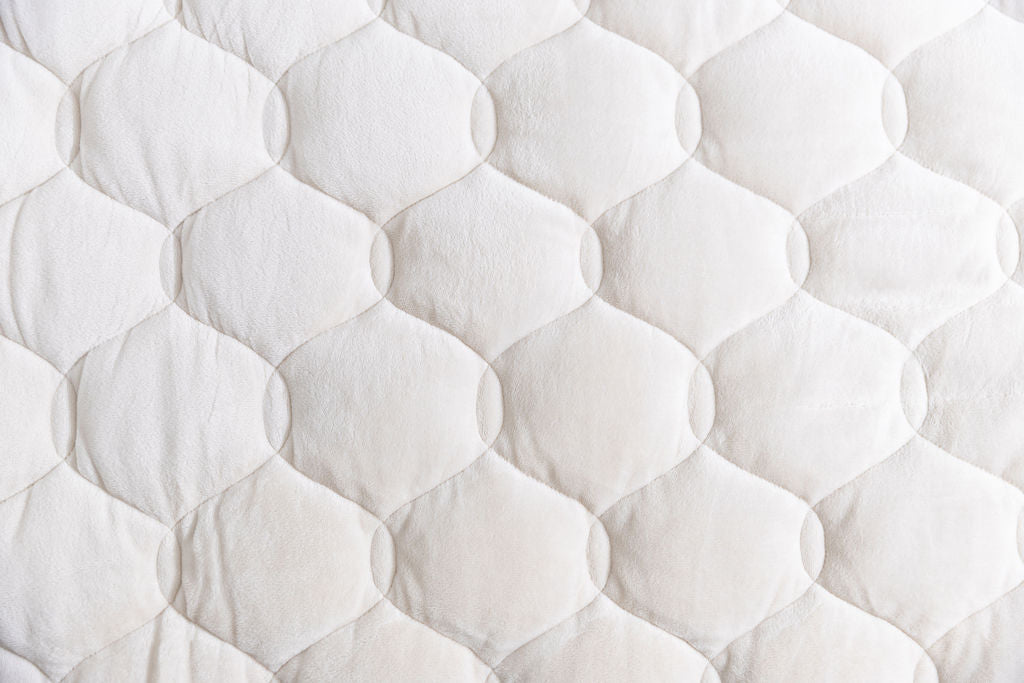 A close up of the cream minky lining of the blanket