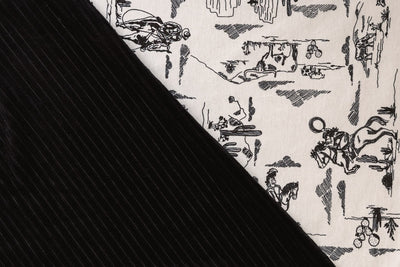 A close-up front and back view of a cream and black western printed travel blanket. 