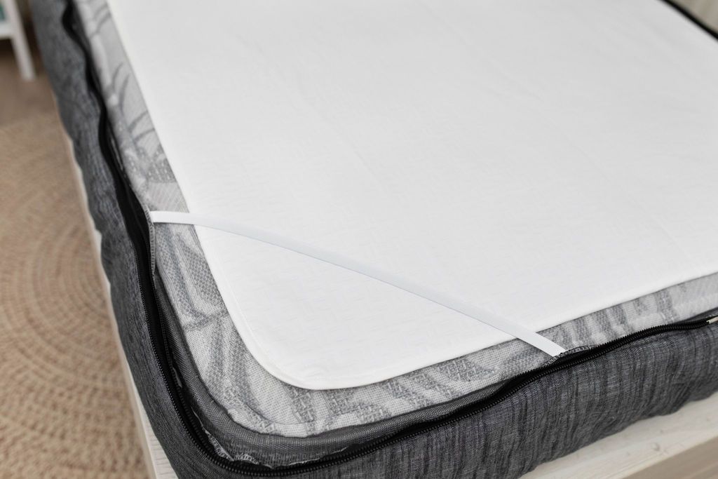 tight corner shot of a white absorbent accident bedding pad 