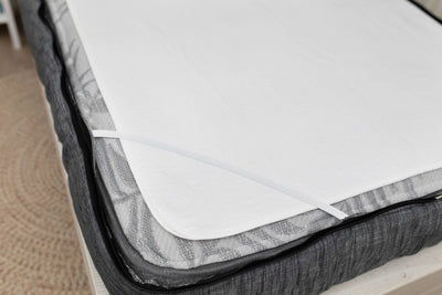 tight corner shot of a white absorbent accident bedding pad 