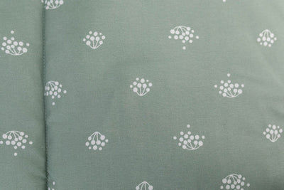 A closeup of the inside lining of a set of sage green kids zipper bedding
