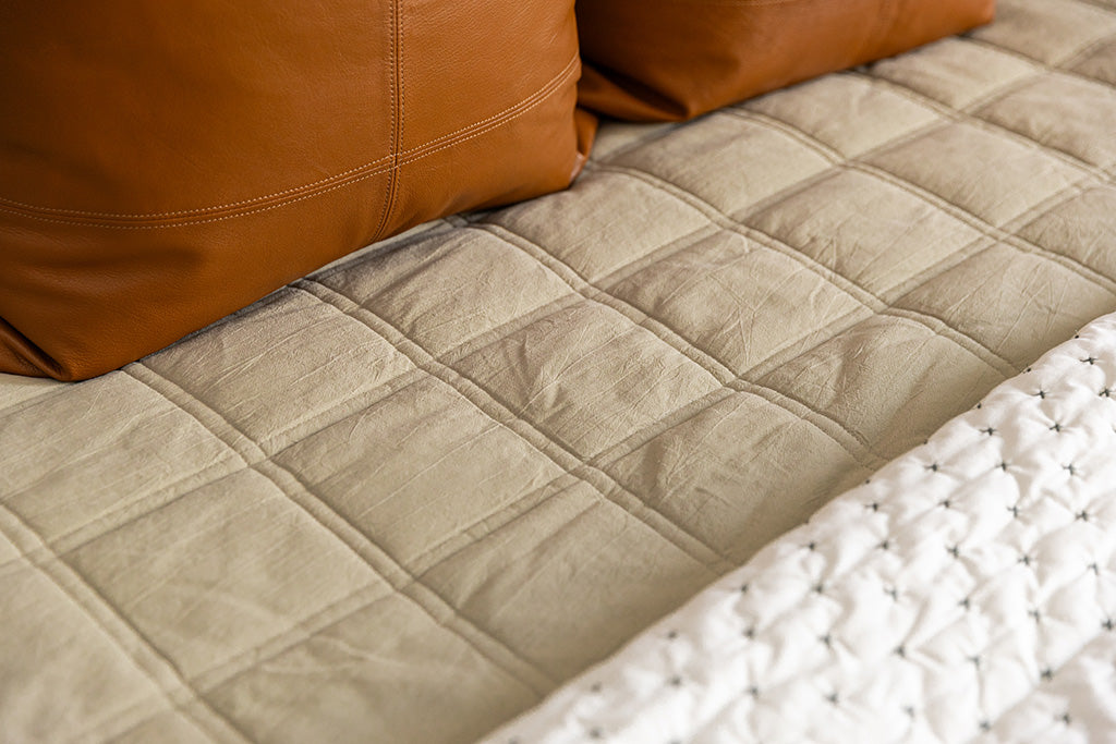 Close up photo of khaki zipper bedding.