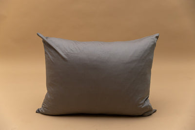 A gray zipper pillowcase displayed on a tan backdrop.