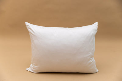 A white zipper pillowcase displayed on a tan backdrop.