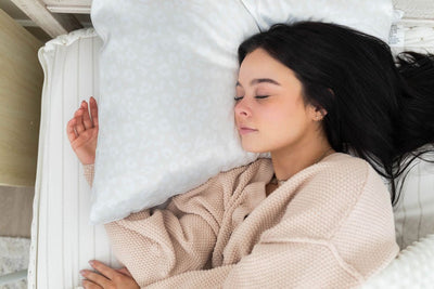 Woman sleeping on white silky satin pillowcase