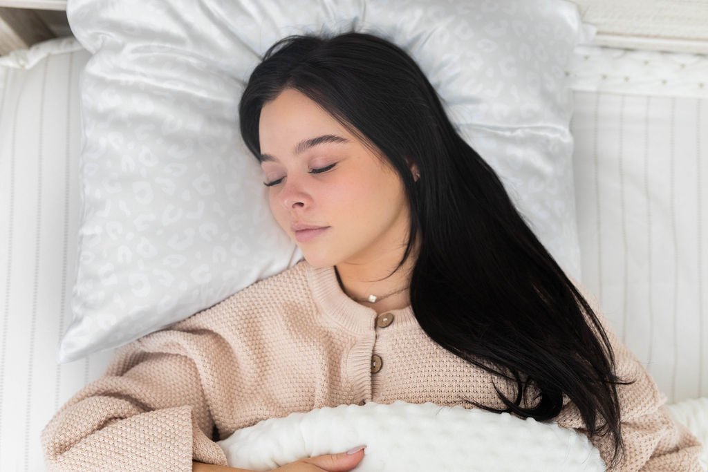 Woman sleeping on white silky satin pillowcase