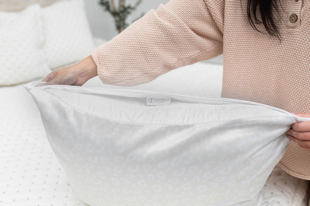 Woman holding unzipped satin pillowcase