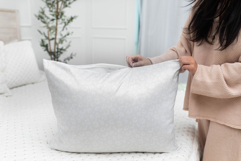 Woman zipping up satin pillowcase