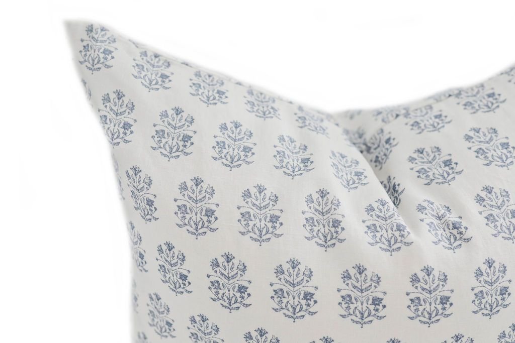 Close up of white euro pillow with blue floral pattern design 