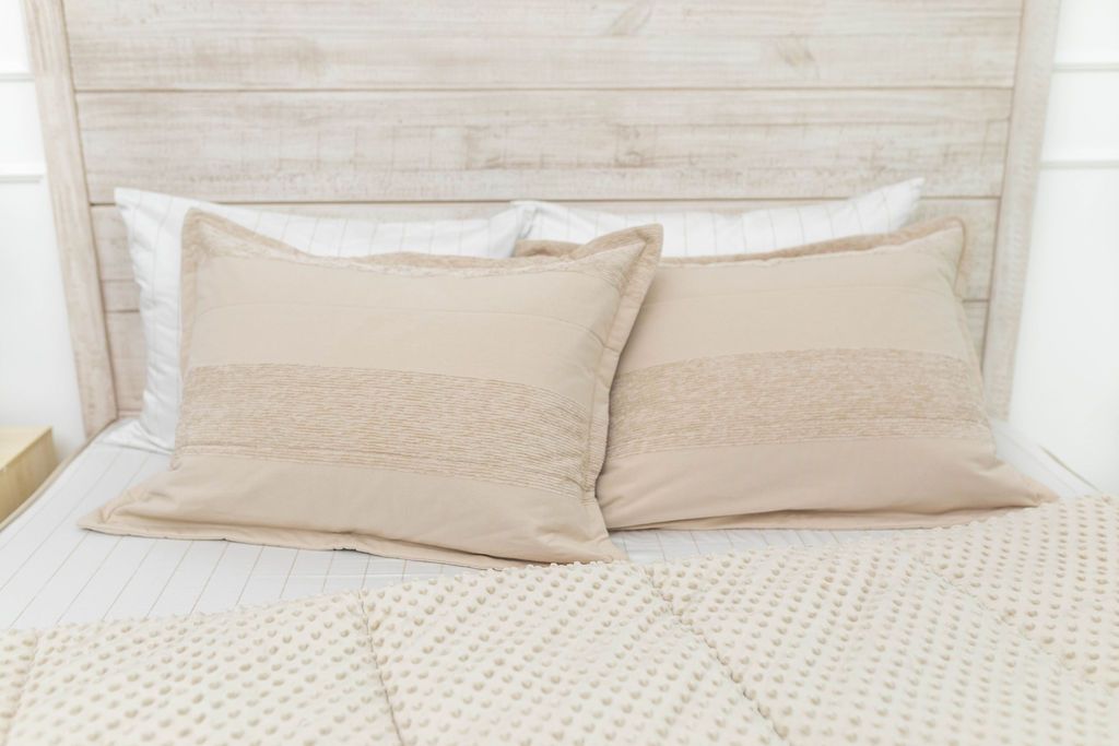 Tan and white pillowcase and sham on tan zipper bedding