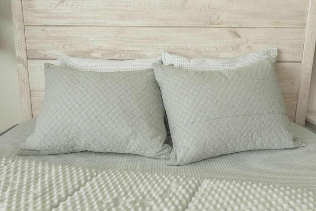 Sage green zipper bedding with sage green pillow cases and shams. Unzipped zipper bedding revealing minky inner lining