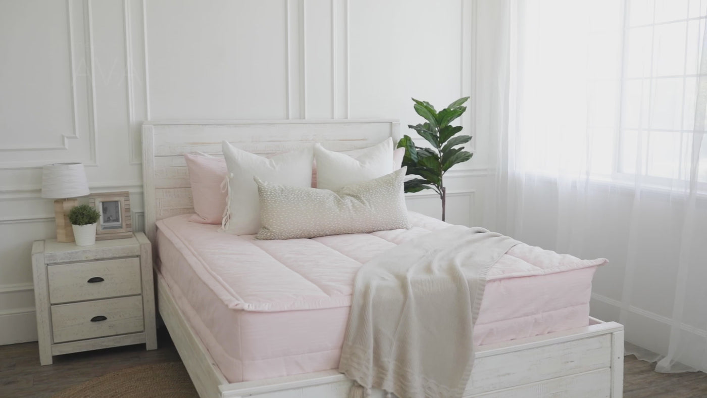 Video highlighting pink zipper bedding textures and minky lining. Pink, white, and cream decorative pillows.